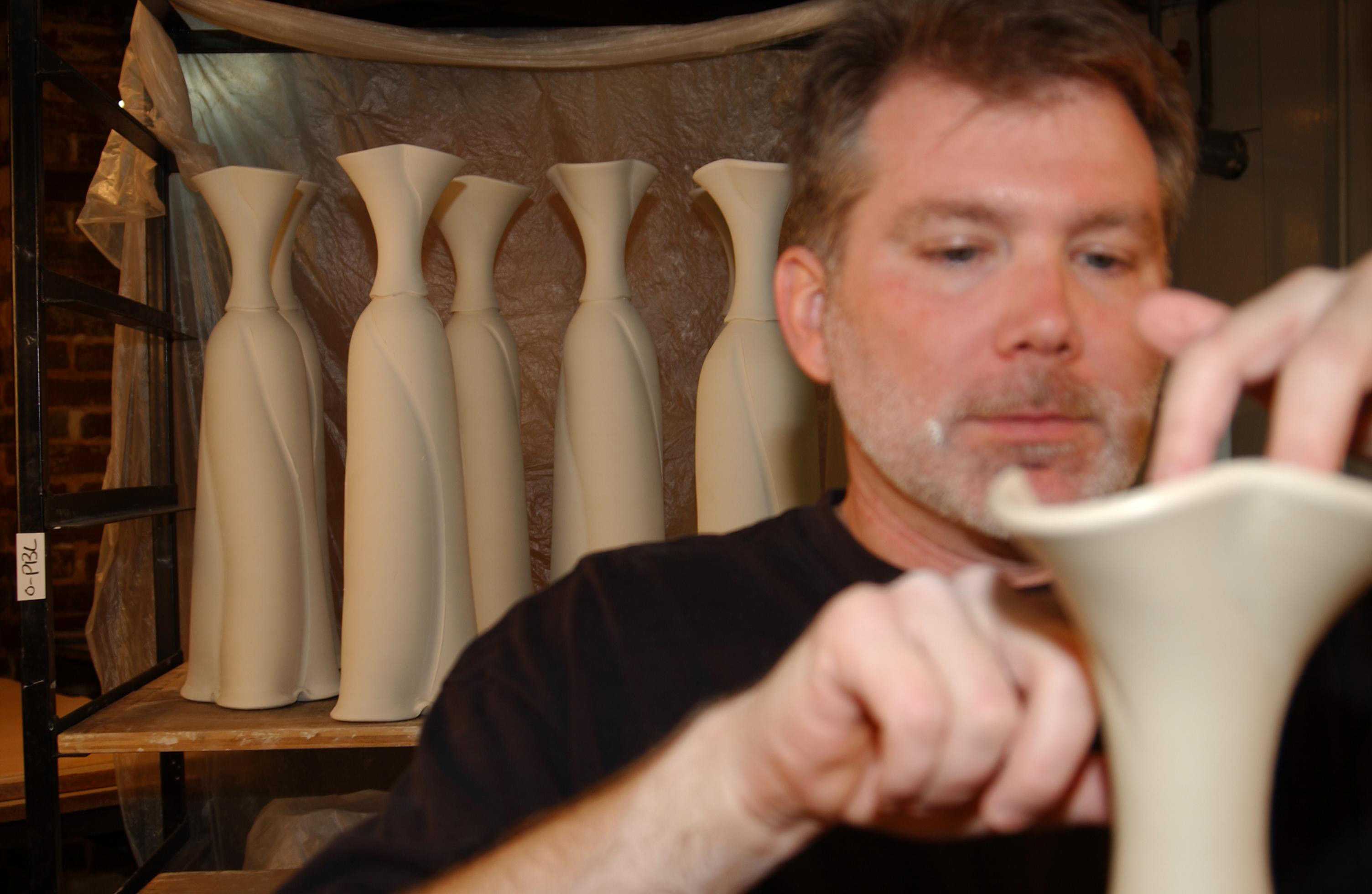 conner burns working on the final detail of a vase