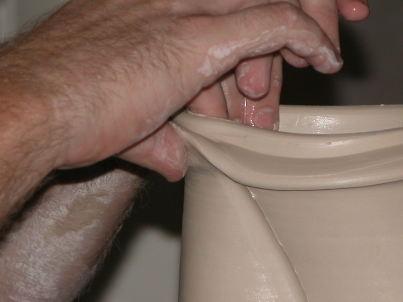 conner burns working on the final detail of a pitcher